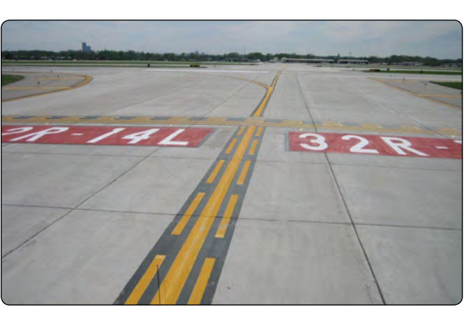 Figure 14-12. White runway markings on pavement: designation numbers, threshold and aiming-point stripes.